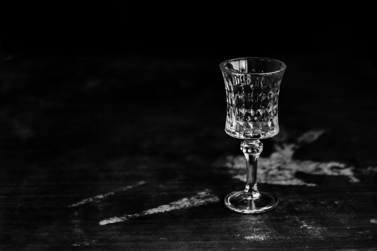 A single cut-crystal glass on a dark surface